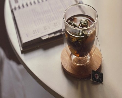 A notebook and tea showing a well planned balanced daily routine